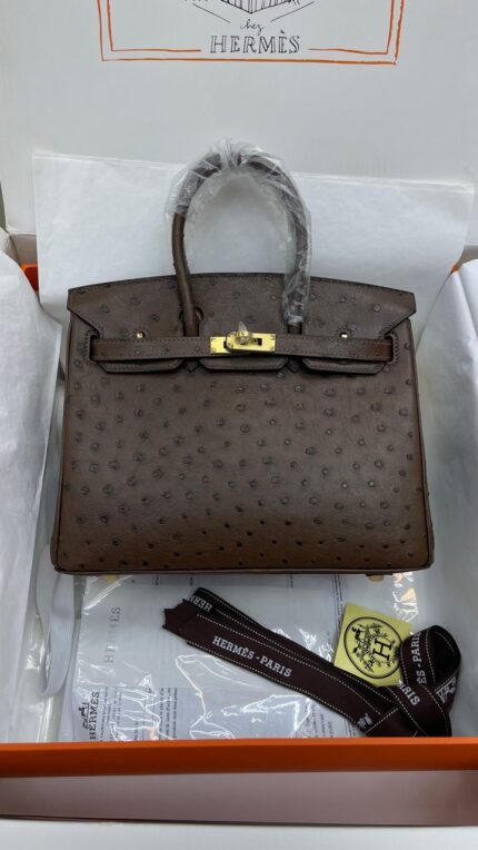 Hermès Birkin handbag made of brown ostrich leather with gold hardware.