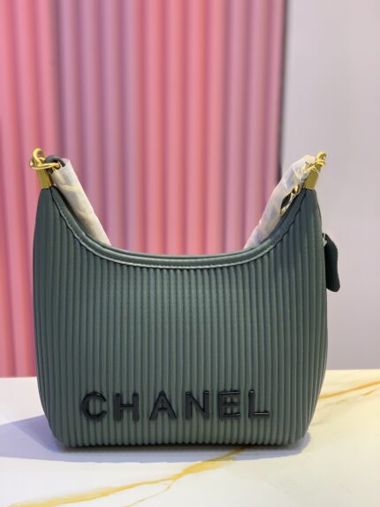 Chanel handbag in a green/teal color with a ribbed material