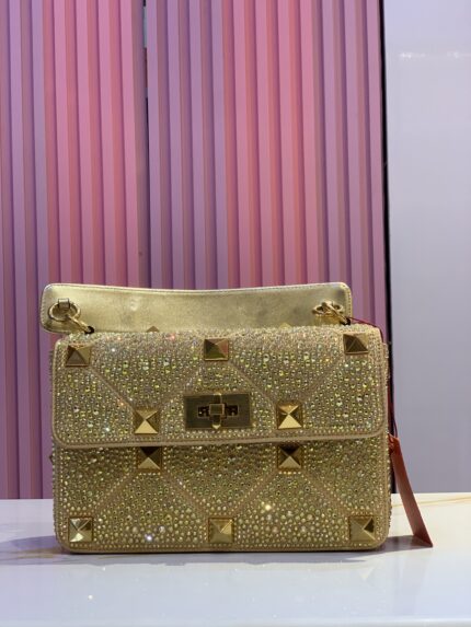 Golden sparkling crossbody shoulder bag with stud embellishments