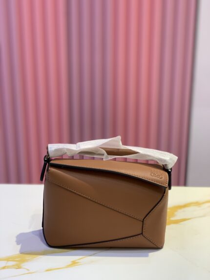 Loewe Puzzle Edge mini leather tote bag in a tanned brown classic calfskin
