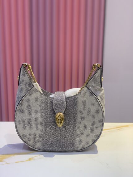 Bvlgari Serpenti Ellipse crossbody bag in a grey or ivory calf leather with a spotted pattern