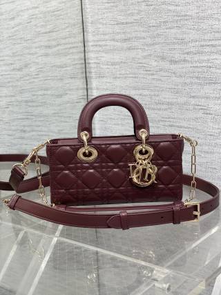 Dior Lady D-Joy bag in a dark color with gold-finish metal D.I.O.R. charms