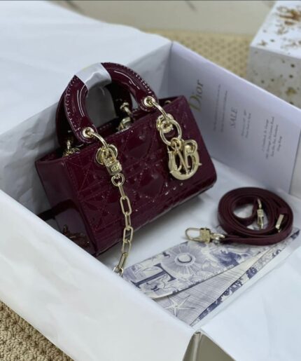 Lady Dior bag in a dark red patent leather finish